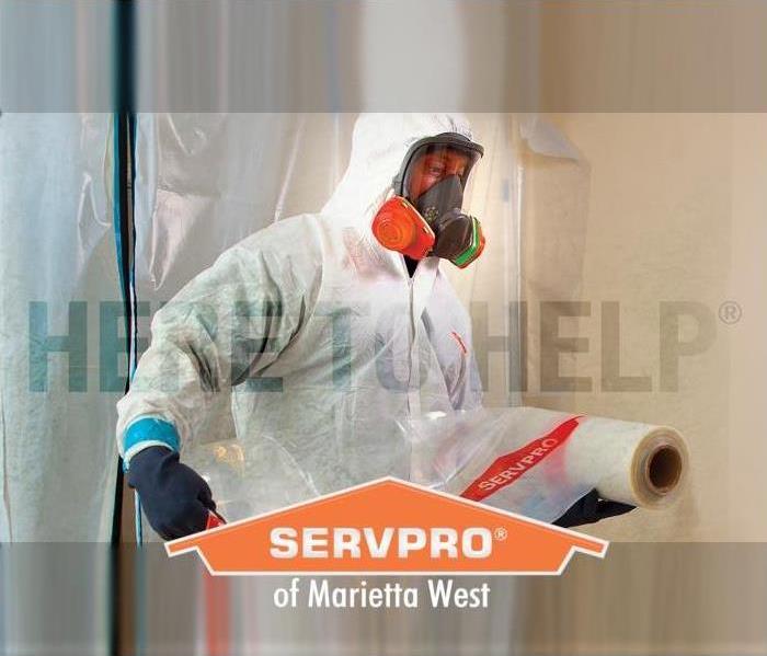 SERVPRO employee in PPE prepping an area for cleaning