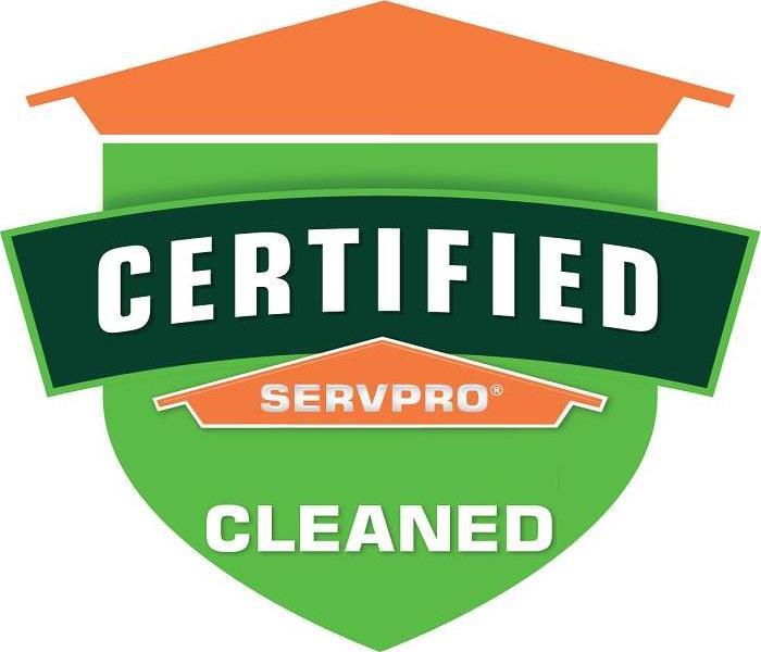  Table tent signs describing the Certified: SERVPRO Cleaned program on top of a wooden table